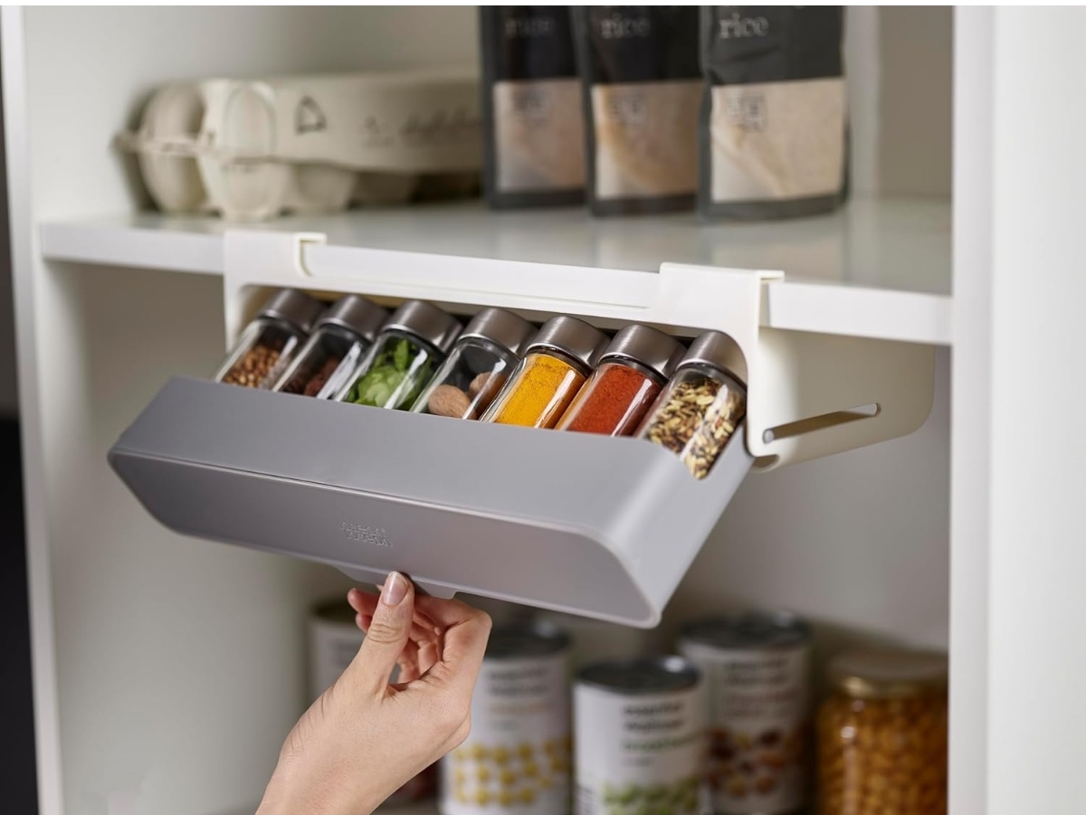 Joseph Joseph under-shelf pull-out spice rack mounted beneath a kitchen cabinet shelf